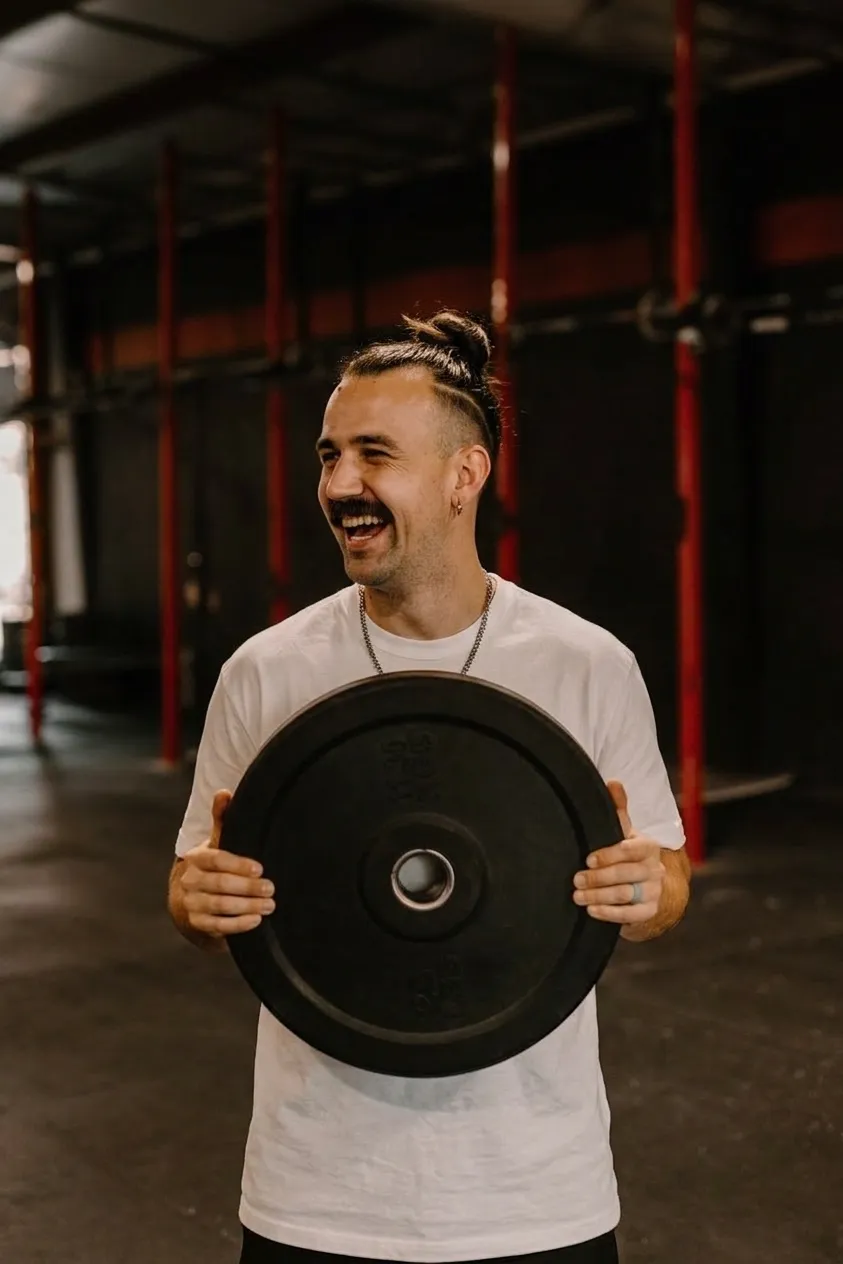 Athlete with Weight Plate In Gym